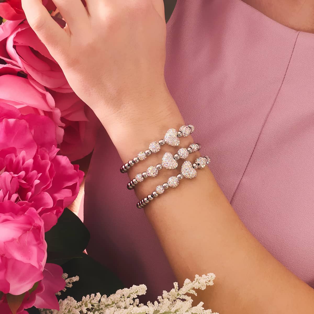 Unicorn White Crystal Kikiballa Cascade Heart Bracelet featuring sparkling crystal hearts and silver beads on an elastic band by NOGU